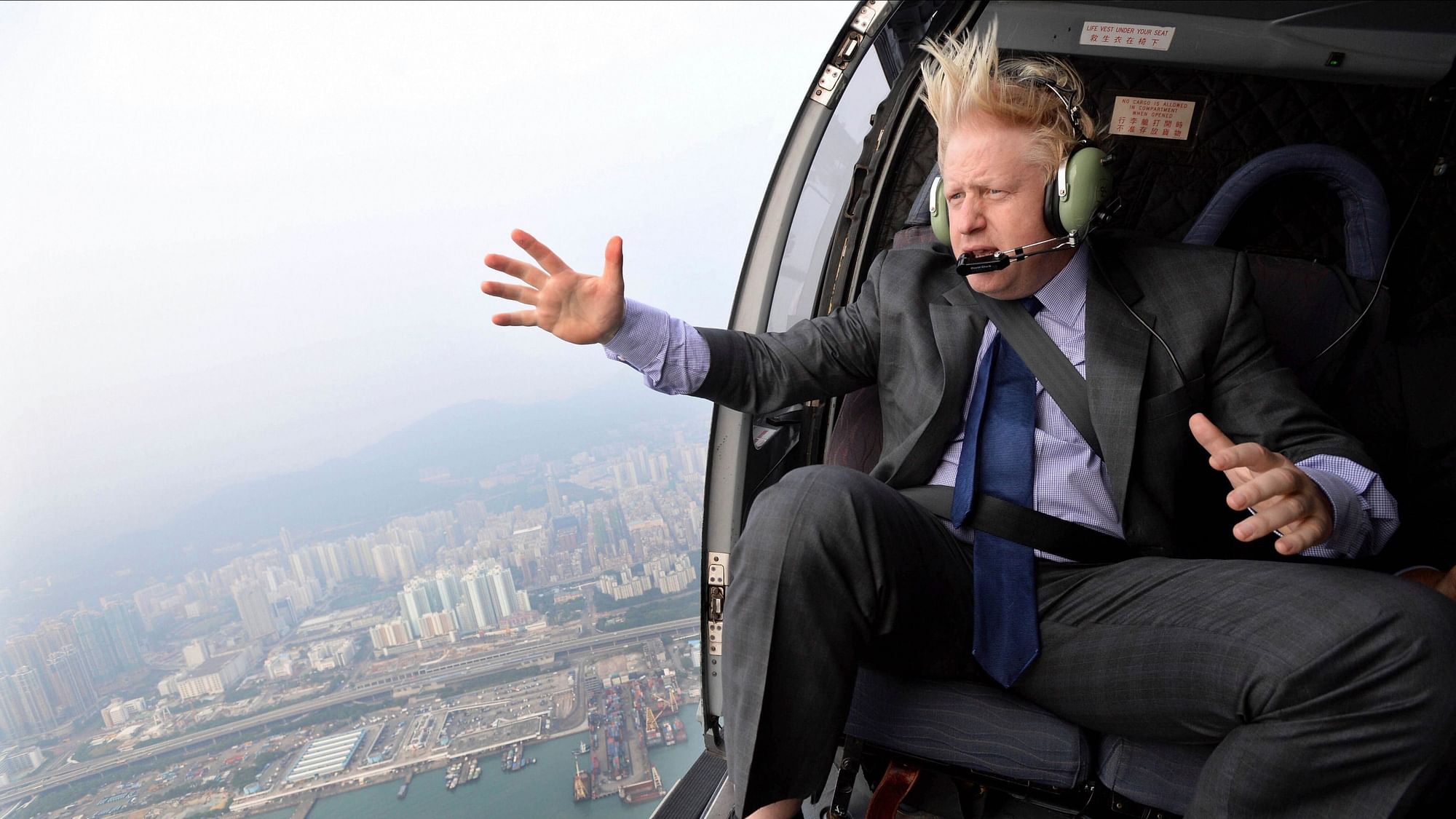 In this 2013 file photo, the then Mayor of London Boris Johnson looks at the skyline during a helicopter ride over Hong Kong.