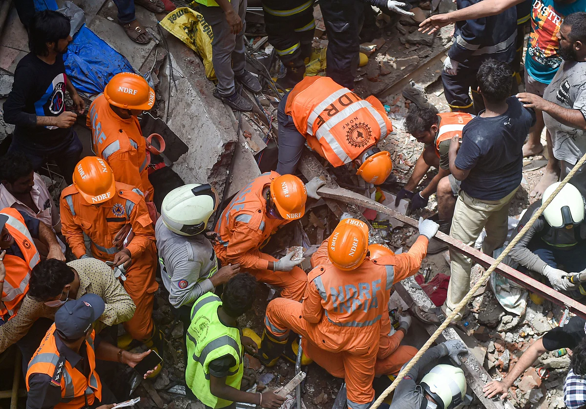 Fire Brigade and NDRF personnel carry out rescue works after the collapse of the four-storey Kesarbai building at Dongri in Mumbai on 16 July 2019. 