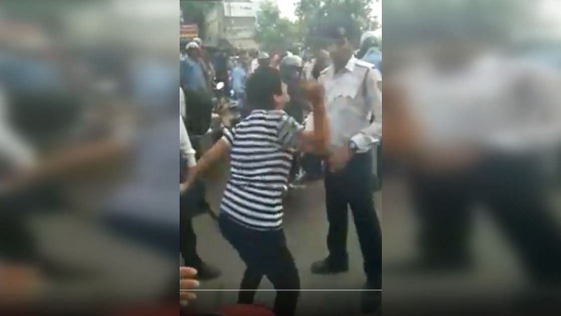 A screengrab of the video in which the woman can be seen pushing the traffic policeman.