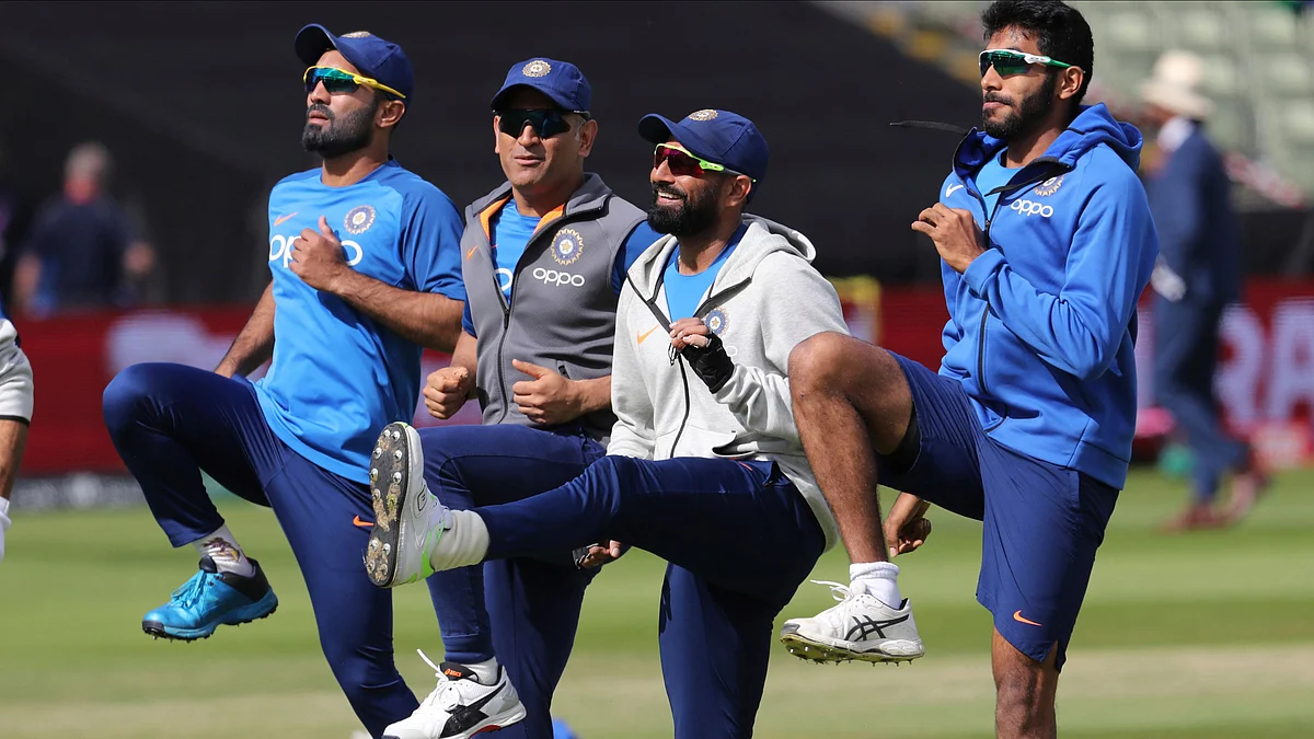 Dinesh Karthik warms up with his team-mates ahead of the match against Bangladesh.