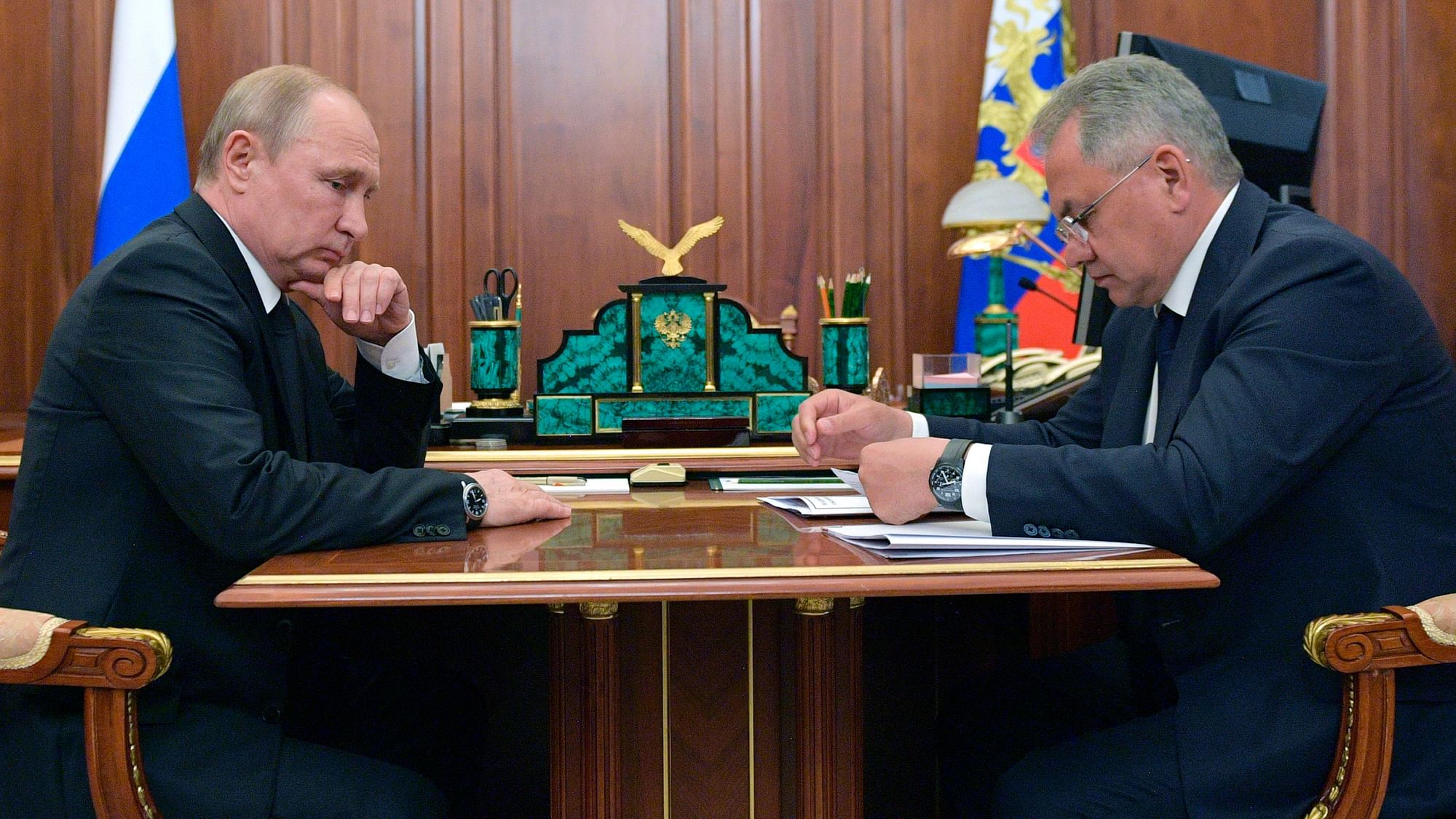 Russian President Vladimir Putin listens to Russian Defense Minister Sergei Shoigu during their meeting in the Kremlin in Moscow, Russia, Tuesday, 2 July.