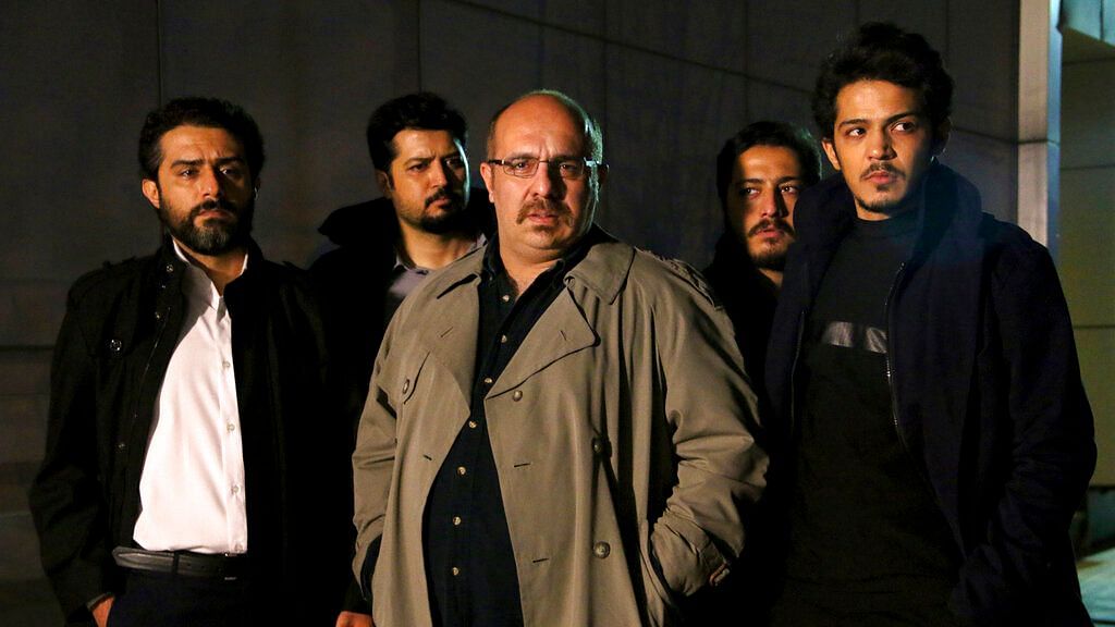 This undated promotional handout still from the Iranian state TV series, ‘Gando’, shows actor Payam Dehkordi, center, who plays a character apparently based on Washington Post journalist Jason Rezaian, among other actors. 