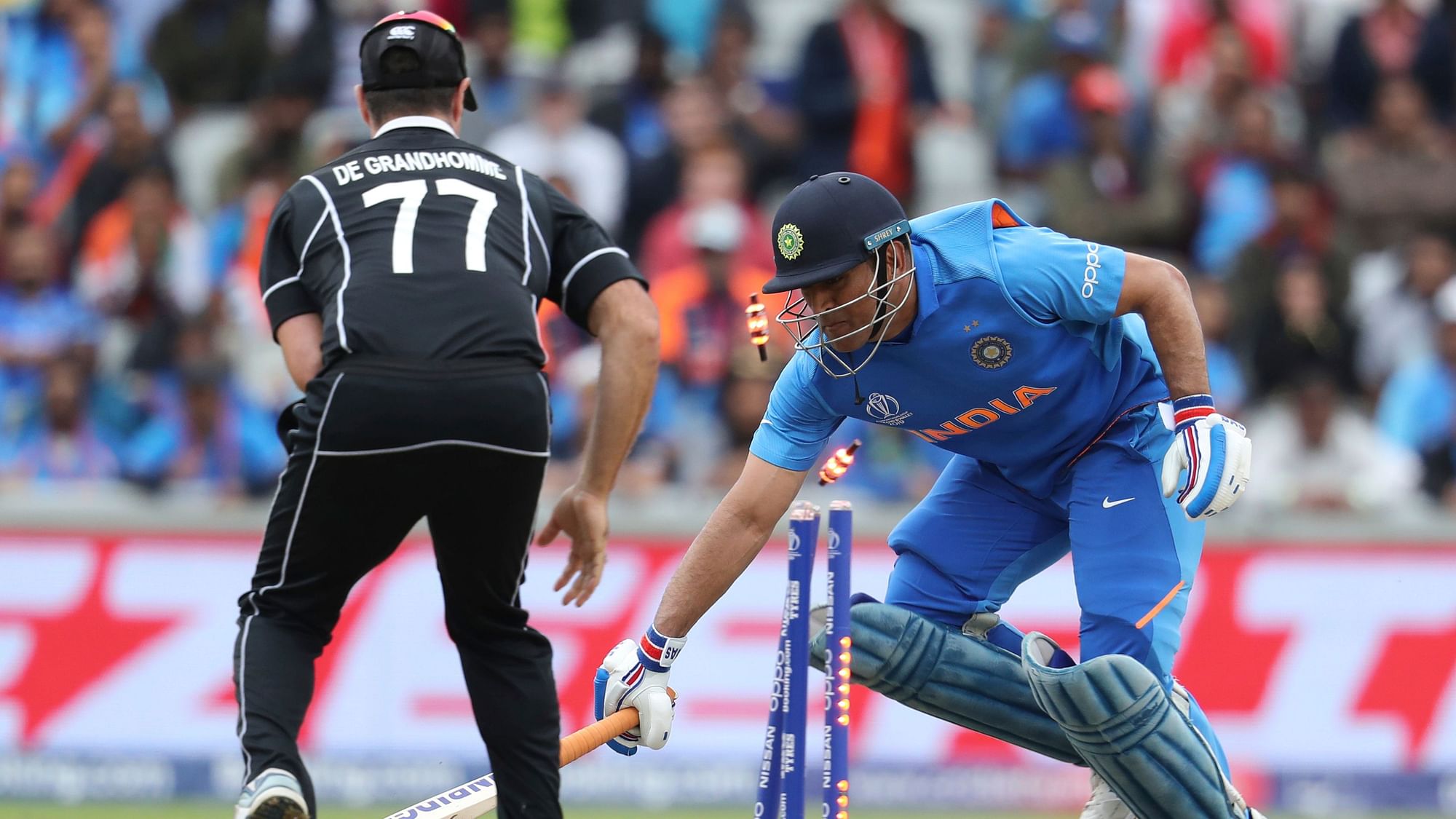 MS Dhoni was dismissed for 50 by a direct hit from Martin Guptill, with India still needing 24 runs for a win.