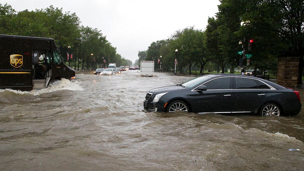 Heavy rainfall flooded the intersection of 15th Street and Constitution Ave., NW stalling cars in the street, Monday, July 8, Washington.