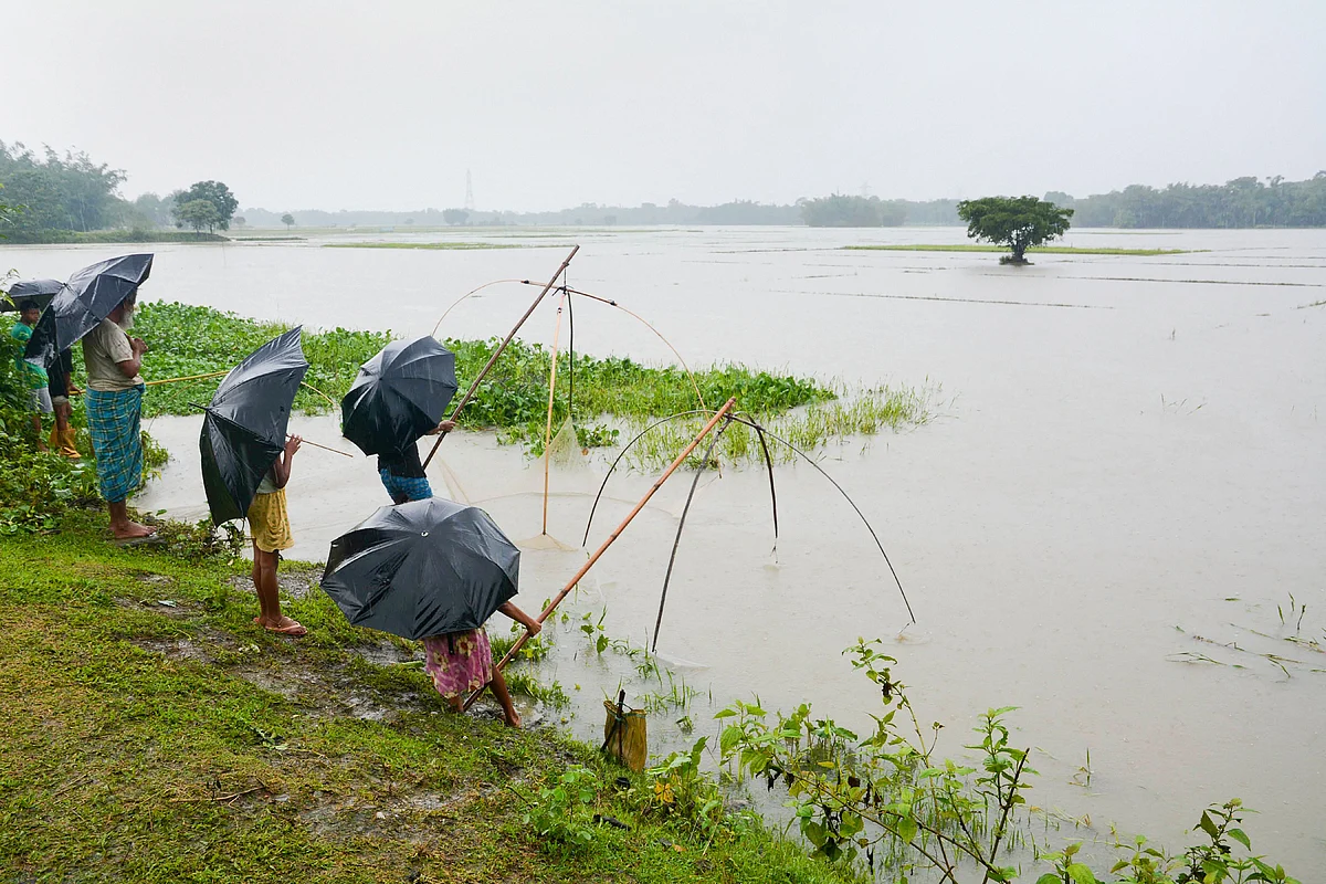 Villagers spread their fishing net to catch fish in flood waters at Hakata, in Baska, Saturday, 13 July. 