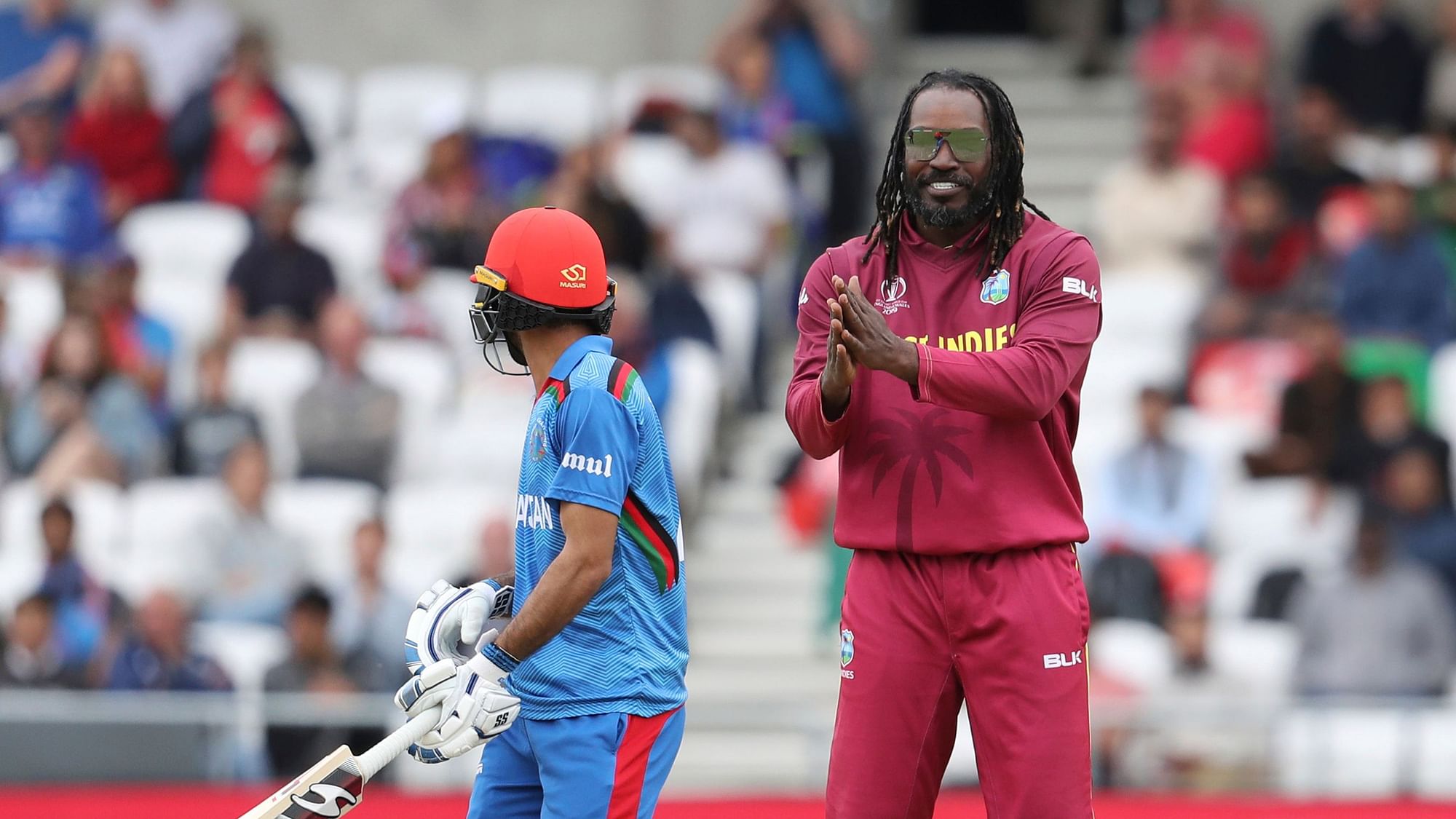 West Indies’ Chris Gayle, right, applauds Afghanistan’s Ikram Ali as he walks back to the pavilion after getting out on 86.