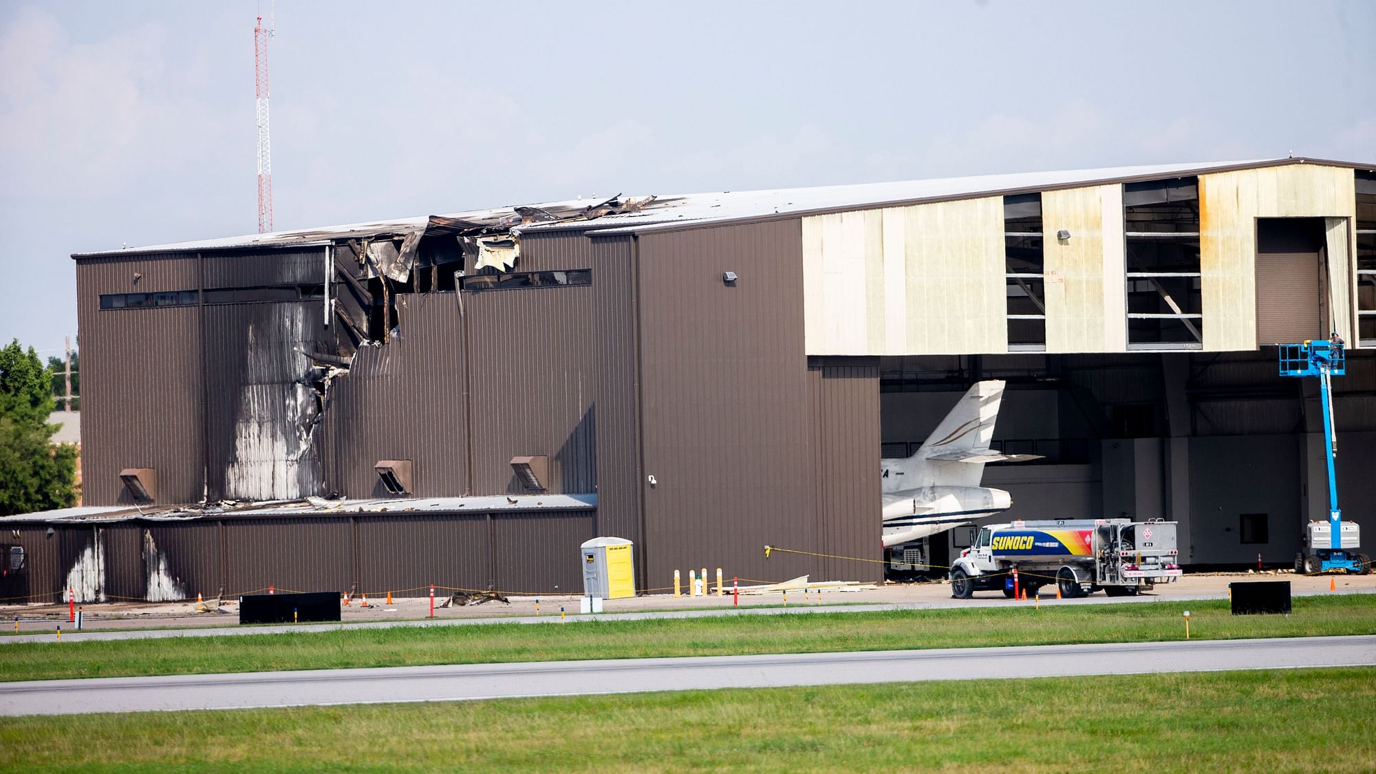 Damage is seen to a hangar after a twin-engine plane crashed into the building at Addison Airport in Addison, Texas.