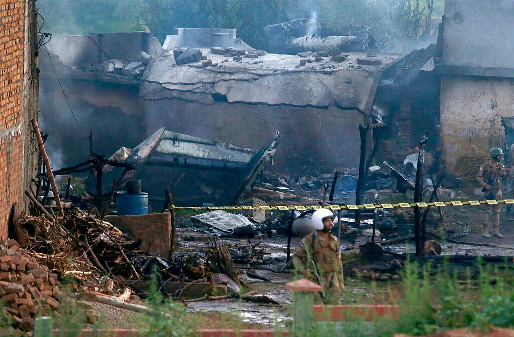 Pakistan army soldier stands guard the site of a plane crash in Rawalpindi, Pakistan, ON 30 July 2019. 