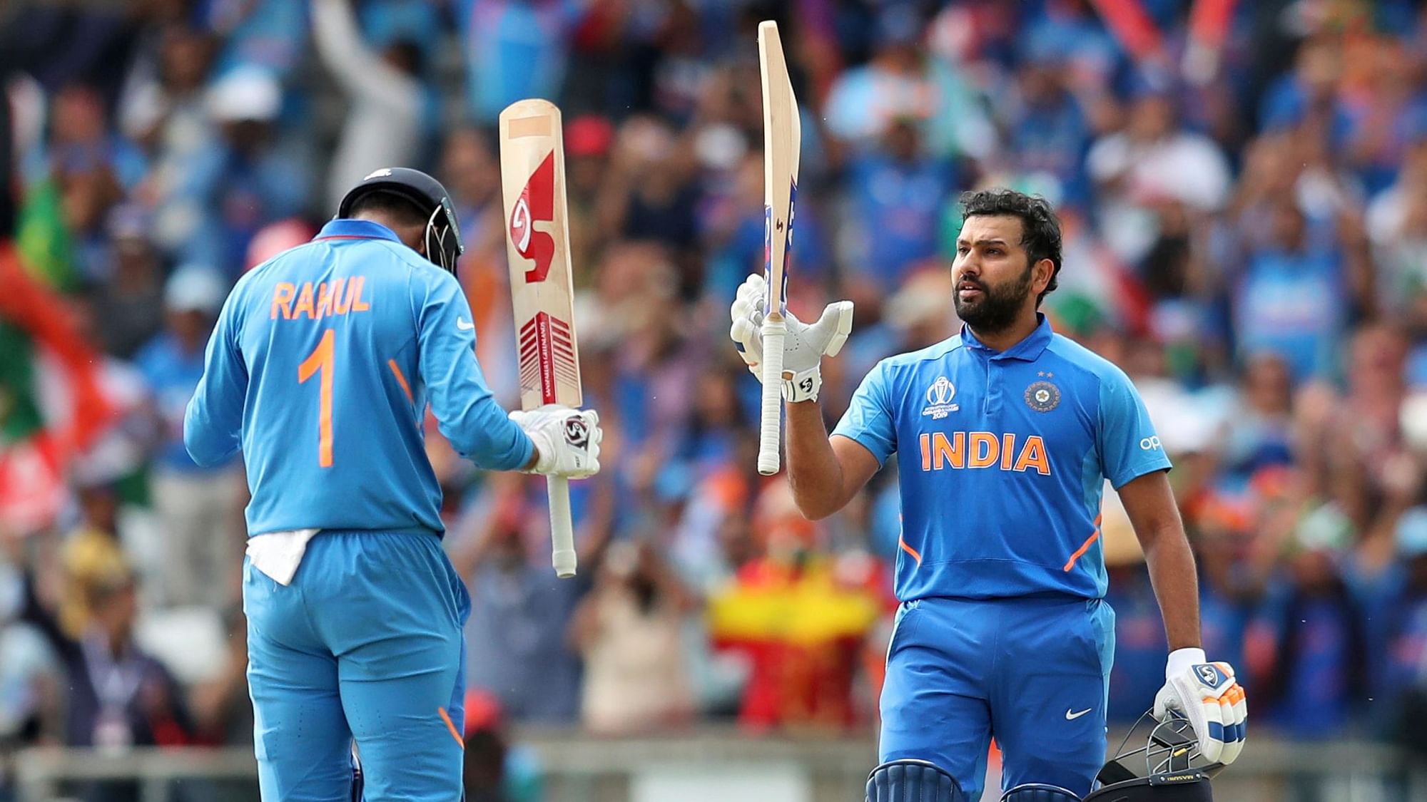 India’s KL Rahul raises his bat and bows to teammate Rohit Sharma, right, as the latter celebrates scoring a century during the Cricket World Cup match.