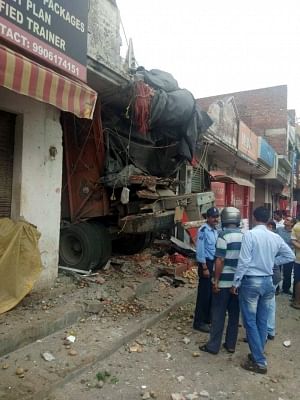 Jammu: The site where a truck loaded with potatoes rammed into an ATM booth in Jammu, on July 17, 2019. According to the police, the driver and the helper of the truck were killed while an ATM guard was injured in this accident. (Photo: IANS)