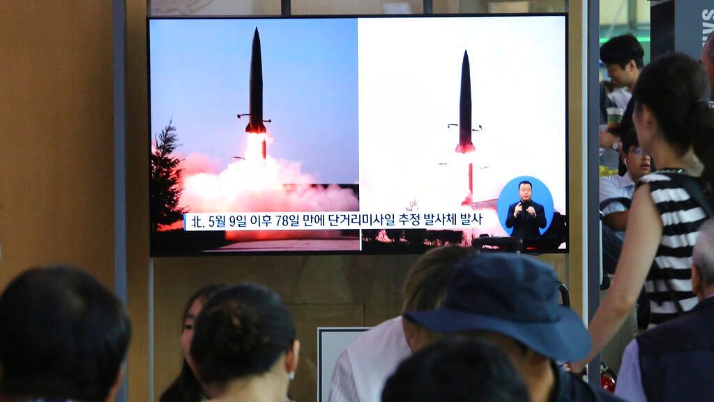 People watch a TV showing file images of North Korea’s missile launch during a news program at the Seoul Railway Station in Seoul, South Korea on 25 July 2019.&nbsp;