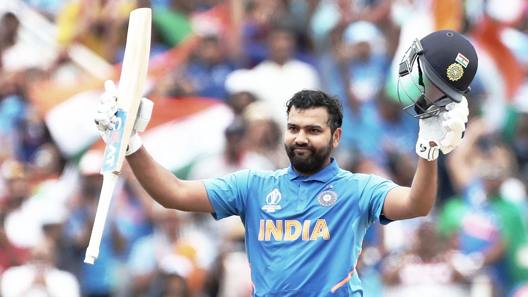 India’s Rohit Sharma raises his bat and helmet to celebrate scoring a century during the Cricket World Cup match.