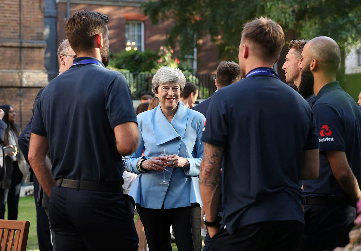 Britain’s Prime Minister Theresa May with the England cricket team after their win in the ICC World Cup 2019.