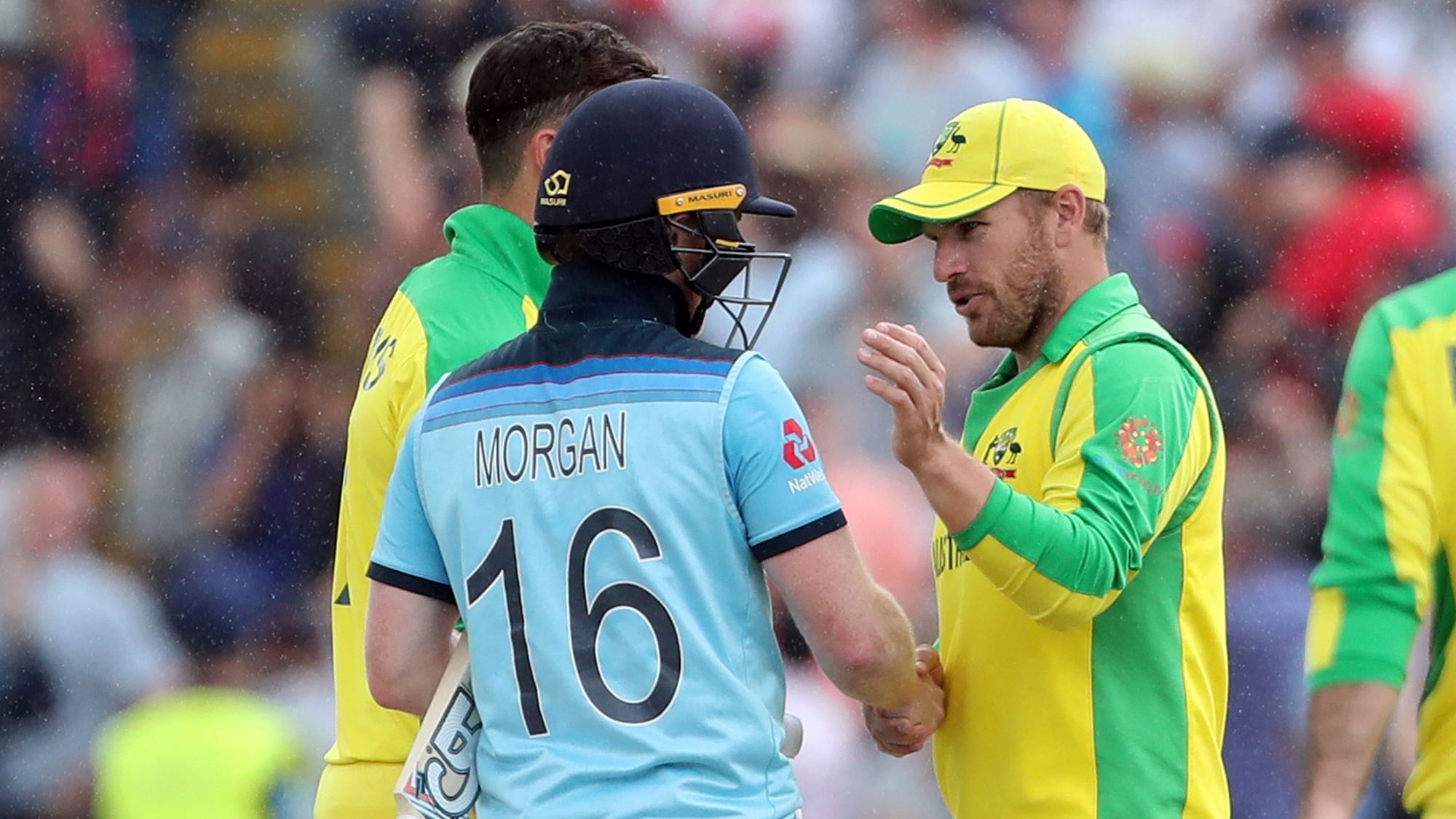 England’s captain Eoin Morgan, left, shakes hands with Australia’s captain Aaron Finch, right, after winning the Cricket World Cup semi-final match between England and Australia at Edgbaston.