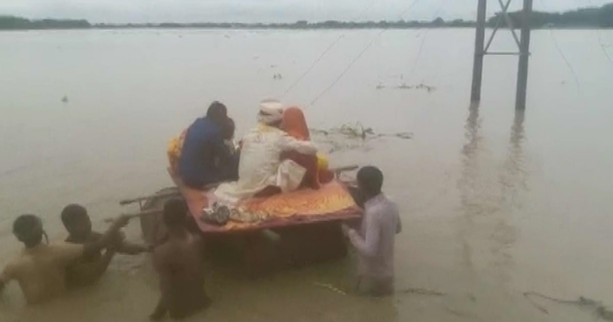 Newlywed Couple Uses Makeshift Boat to Cross Flooded Road in Bihar
