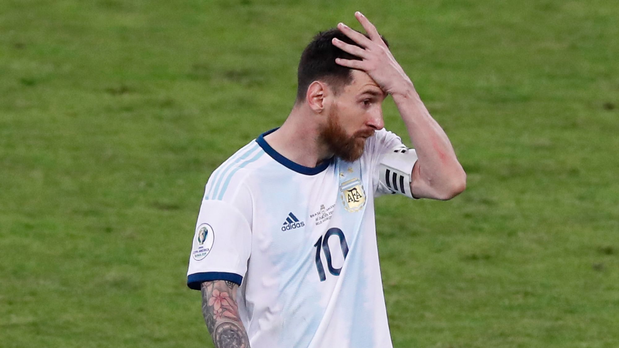 Argentina’s Lionel Messi holds his head as he leaves the field after a Copa America semifinal soccer match against Brazil at the Mineirao stadium in Belo Horizonte, Brazil, Tuesday, July 2, 2019.&nbsp;