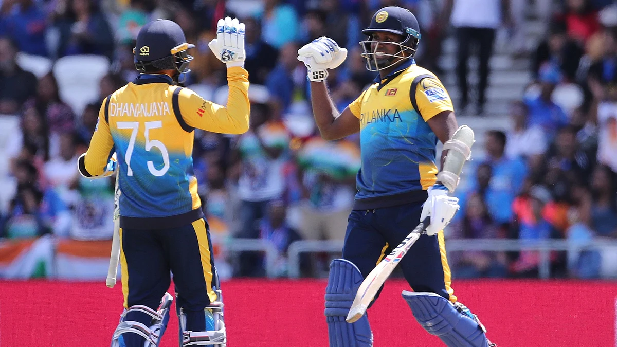 Sri Lanka’s Angelo Mathews (right) celebrates with teammate Dhananjaya de Silva after scoring a century during the Cricket World Cup match.