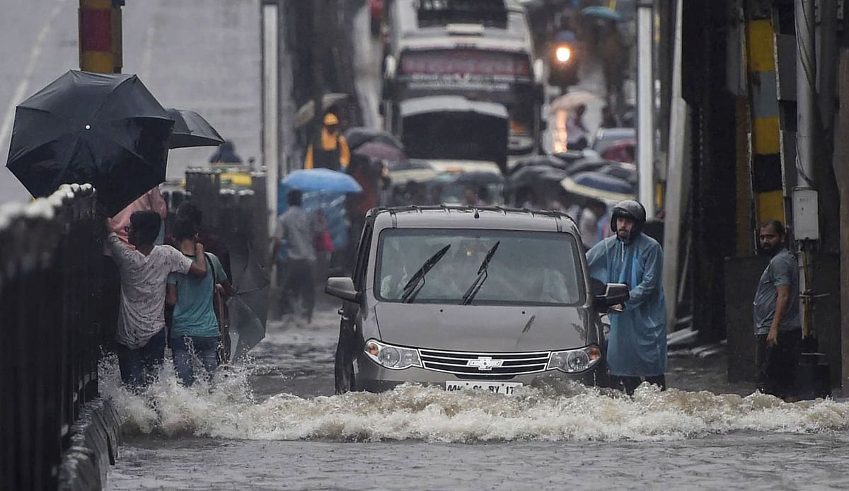 Vehicles move slowly through a waterlogged street following heavy monsoon rain, in Mumbai.