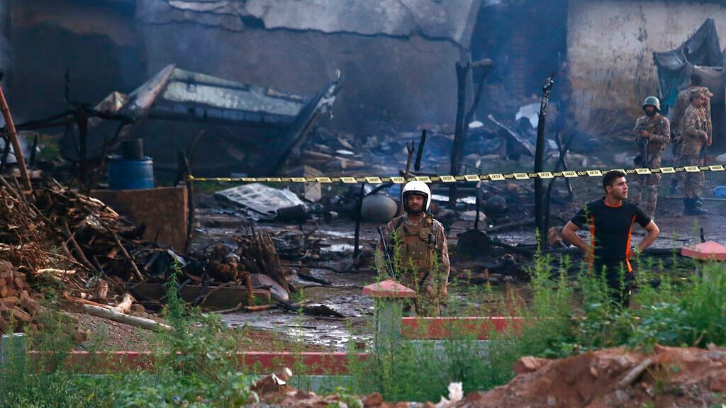 Pakistan army officials examine the site of a plane crash in Rawalpindi, Pakistan, on 30 July 2019.&nbsp;