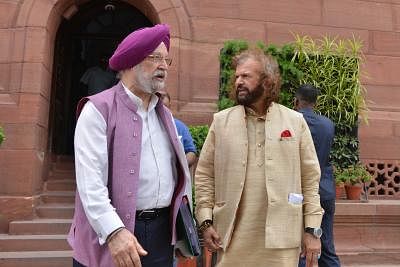 New Delhi: Union MinisterÂ Hardeep Singh Puri in a conversation with BJP MPÂ Hans Raj Hans at Parliament, in New Delhi on July 11, 2019. (Photo: IANS)