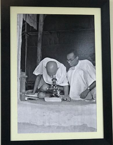 Mahatma Gandhi seeing leprosy germs through a microscope at Sevagram Ashram, Maharashtra India circa 1940.&nbsp;