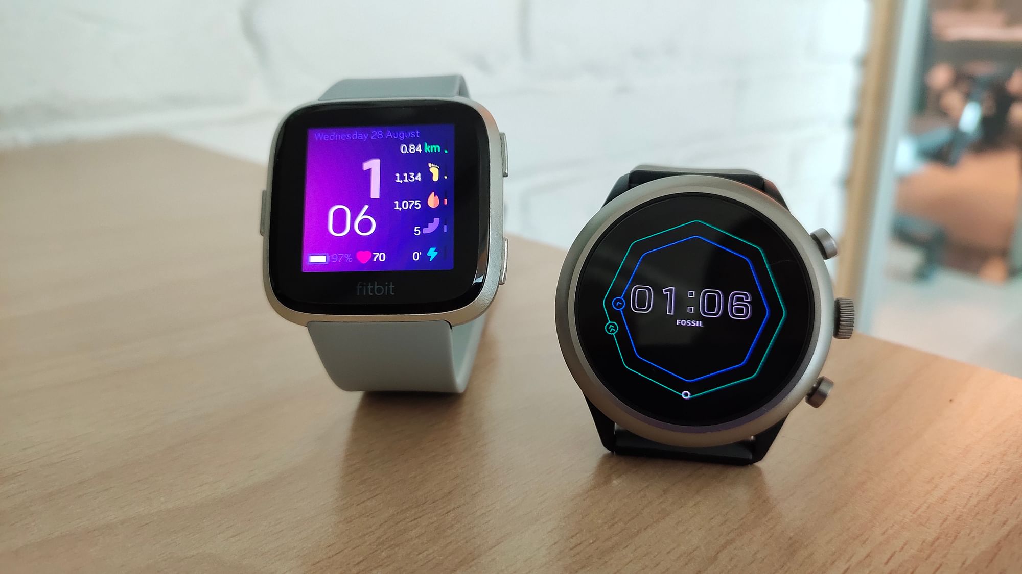 The Fitbit Versa (left) and the Fossil Sport.&nbsp;