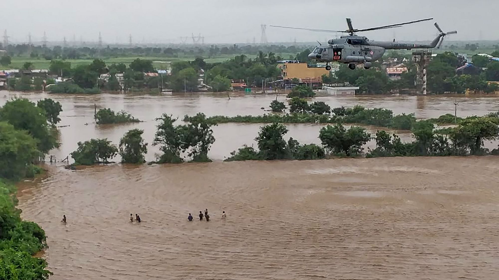 IAF Helicopter flies low to rescue people stranded in the floods in Surat.