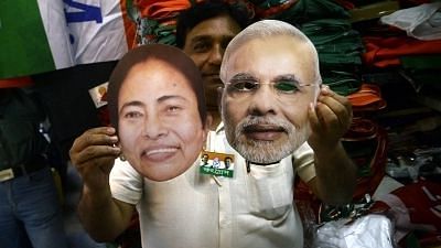 Kolkata: A shopkeeper shows the masks of Prime Minister and BJP leader Narendra Modi and West Bengal Chief Minister and TMC supremo Mamata Banerjee ahead of 2019 Lok Sabha elections, in Kolkata on 29 March, 2019.&nbsp;