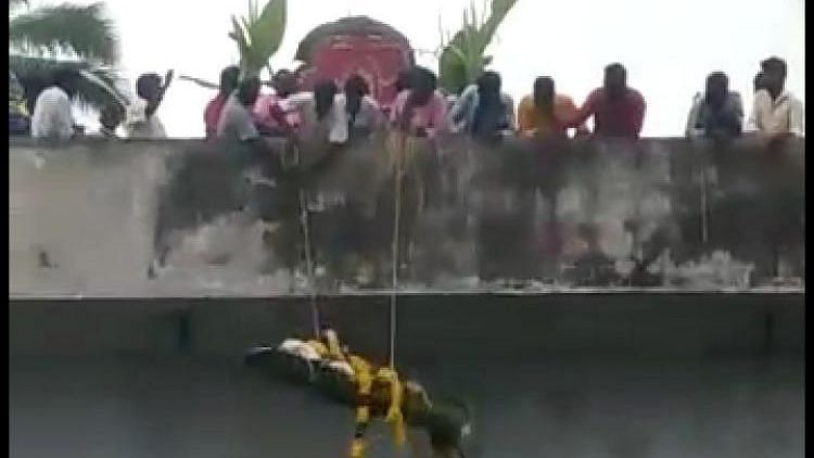 A video grab shows the body being dropped from atop the bridge.