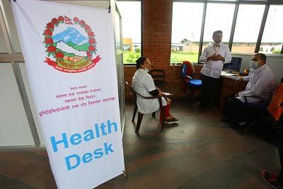 KATHMANDU, Aug. 20, 2014 (Xinhua) -- Doctors work at a health desk at Tribhuwan International Airport in view of the outbreak of Ebola Virus Disease in West African nations in Kathmandu, Nepal, Aug. 20, 2014. (Xinhua/Sunil Sharma/IANS) ****Authorized by ytfs****