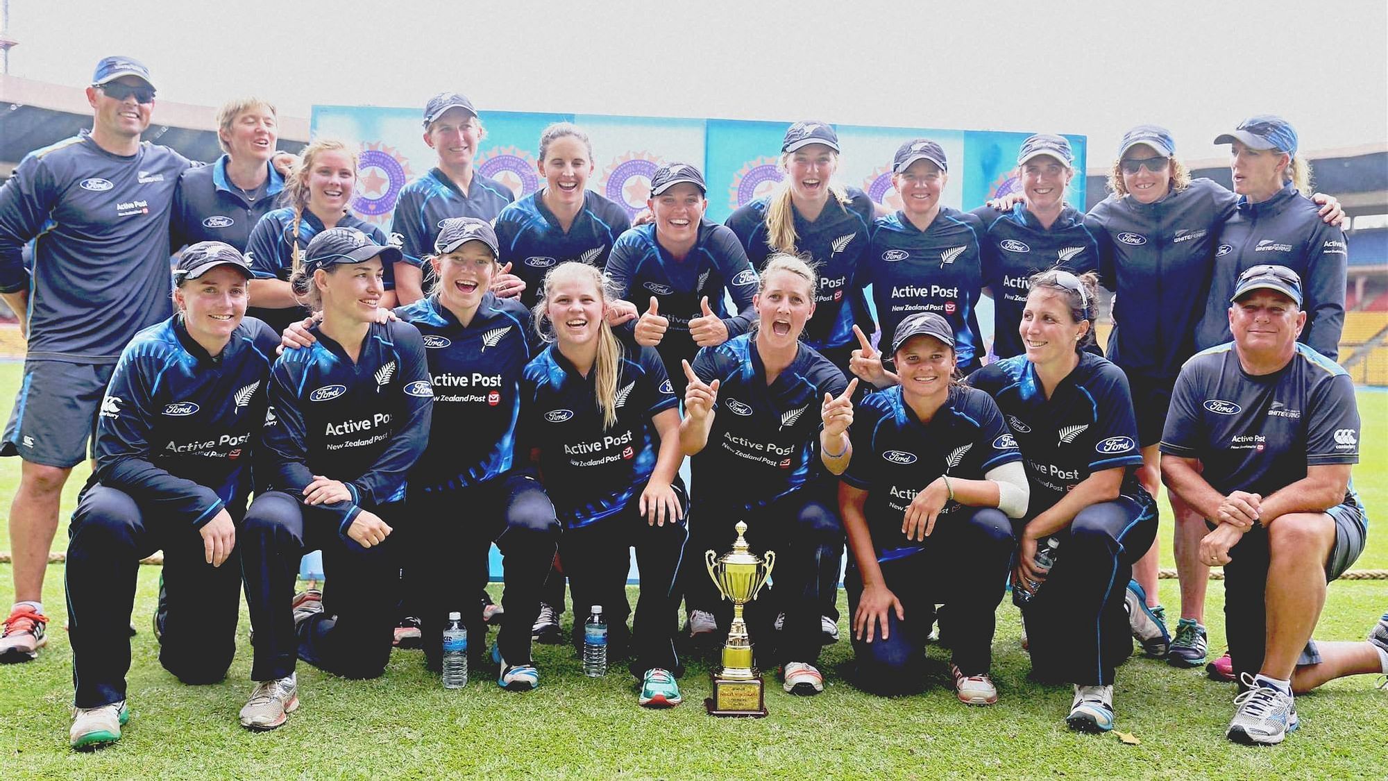New Zealand’s women cricketers pose for a group photo with the T20 trophy after winning the series against India by 2-1 at Chinnaswamy stadium in Bengaluru.