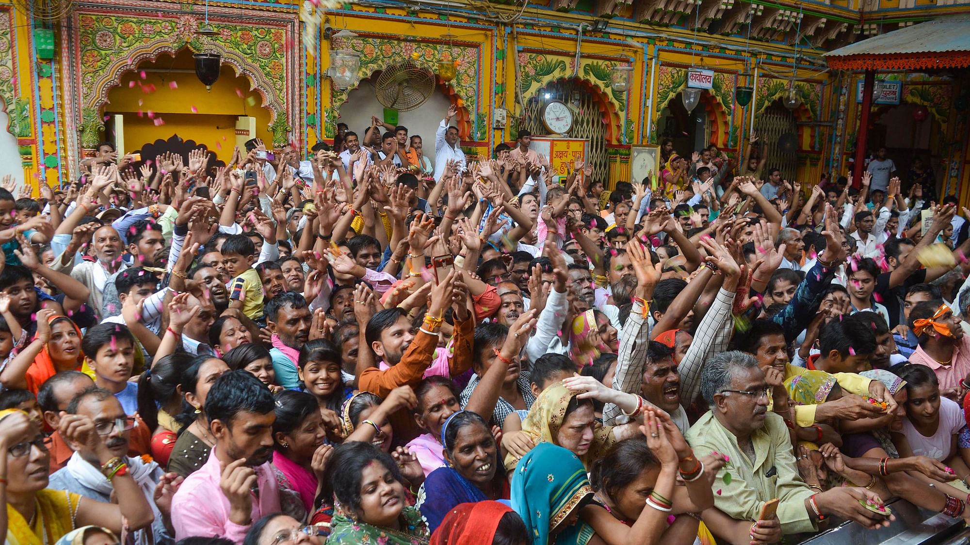 Devotees pay their tributes at Dwarkadheesh Temple on the occasion of Krishna Janmashtami, in Mathura on Saturday, 24 August