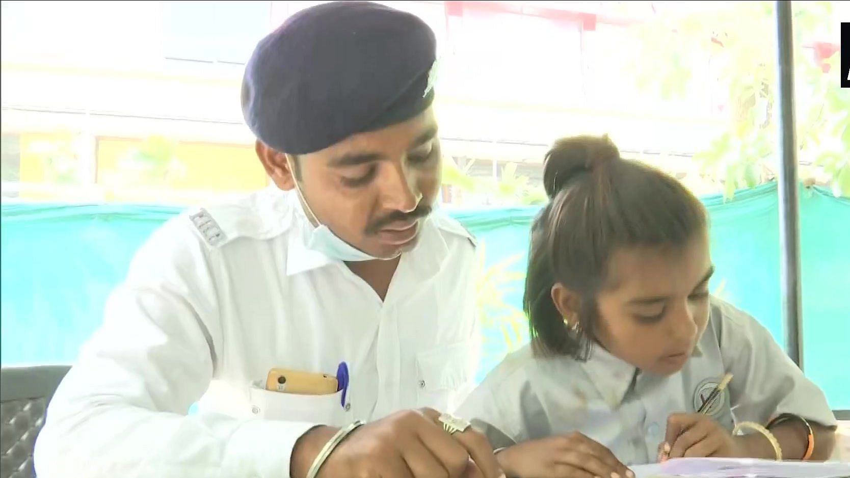 A traffic police personnel teaching his student.