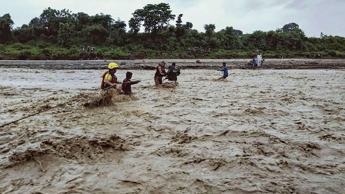 State Disaster Response Fund (SDRF) members rescue people trapped on a river island in Uttarakhand’s Kotdwar on 18 August. &nbsp;