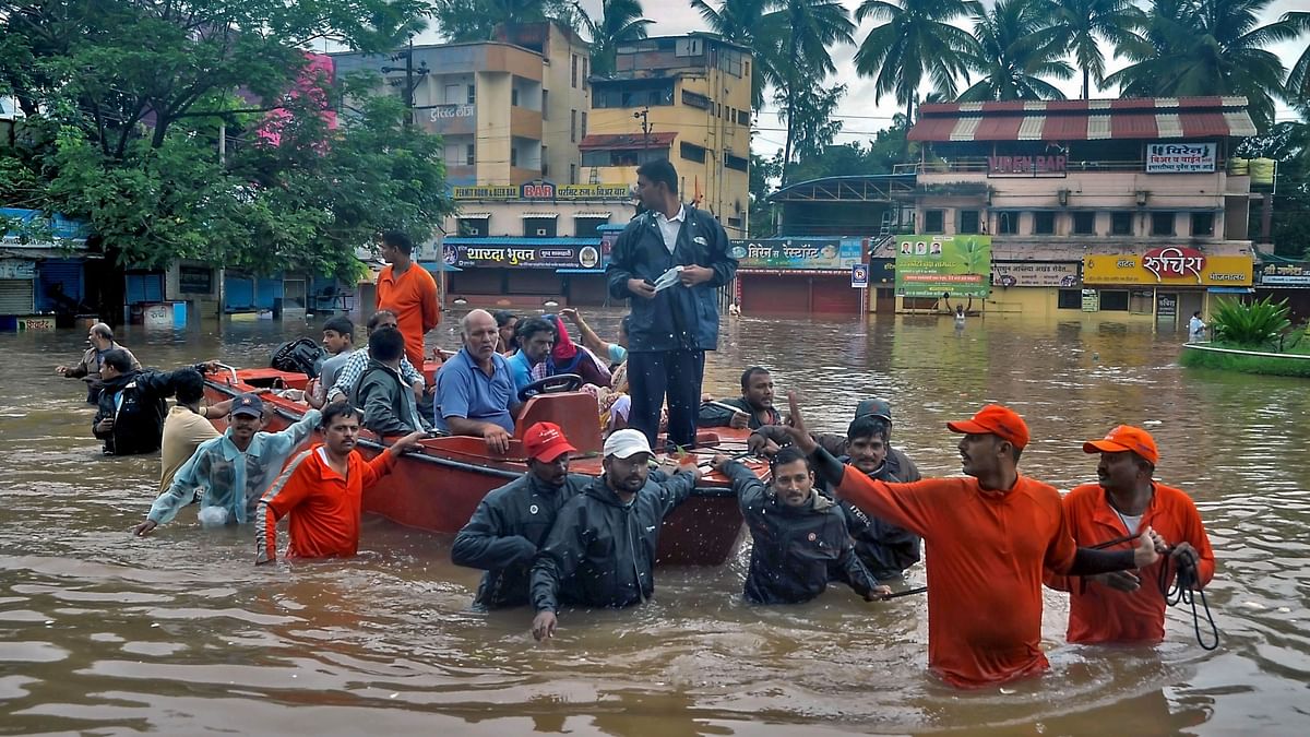 NDRF personnel transport residents to safer place due to overflowing Krishna river during monsoon season, in Sangli, Wednesday, Aug 7.