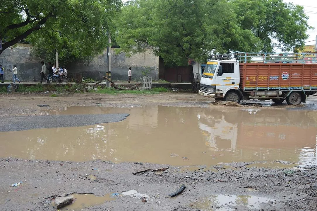 The road in front of the school is filled with big potholes.