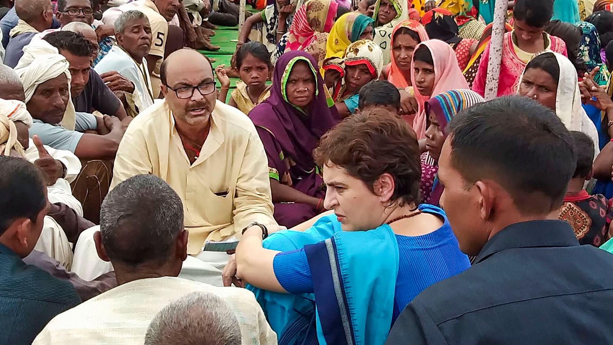 Congress leader Priyanka Gandhi Vadra interacts with locals at Ubha village where ten people had died in a firing incident over a land dispute last month, in Sonbhadra district, Tuesday.