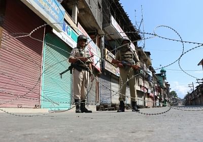 Srinagar: Security personnel enforce curfew imposed by authorities in Srinagar as tension grips Kashmir valley on July 9, 2016. (Photo: IANS)