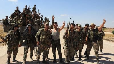 HAMA (SYRIA), Aug. 23, 2019 (Xinhua) -- Syrian soldiers flash victory signs in the town of Morek in the northern countryside of Hama province, Syria, on Aug. 23, 2019. The Syrian army on Friday captured remaining rebel-held areas in the northern countryside of Hama province in central Syria, besieging a Turkish military point in that region, according to a monitor group. (Xinhua/IANS)