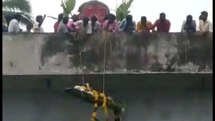 A video grab shows the body being dropped from atop the bridge.