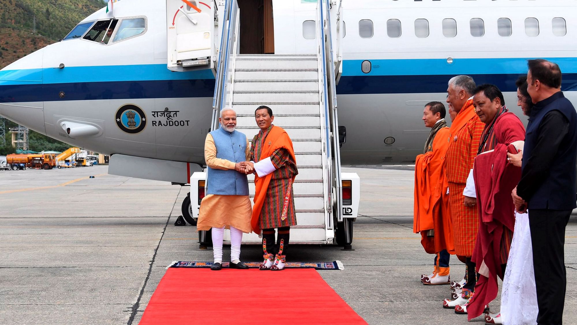 Bhutan PM Tshering receives PM Modi upon landing in Bhutan.