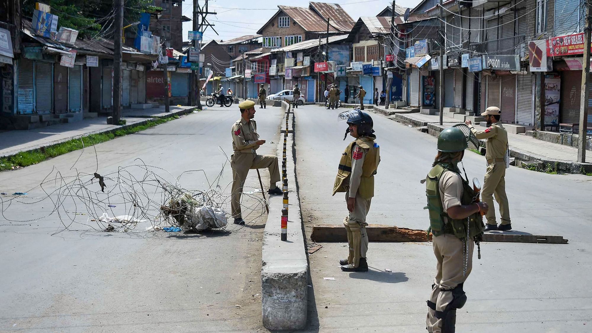 Security personnel stand guard at a checkpoint during restrictions, after Centre abrogated Article 370 and divided Jammu and Kashmir into two Union territories in Srinagar, on Sunday, 18 August.