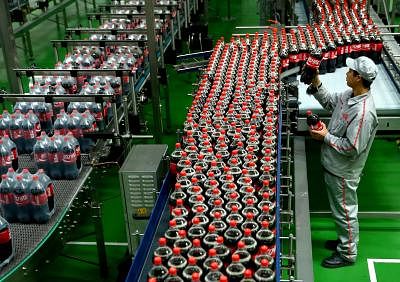 SHIJIAZHUANG, Oct. 24, 2013 (Xinhua/IANS) -- A worker checks the package at the new plant of Coca-Cola in Shijiazhuang, capital of north China