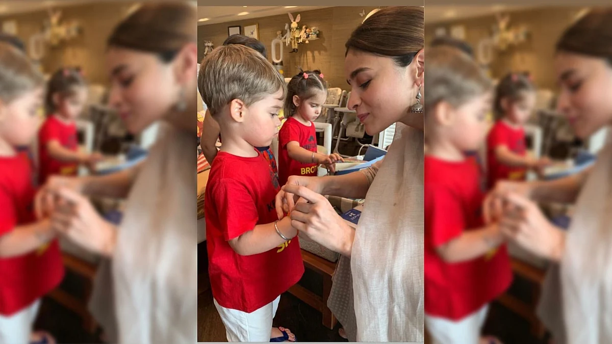Alia Bhatt ties rakhi on Yash Johar’s hand.