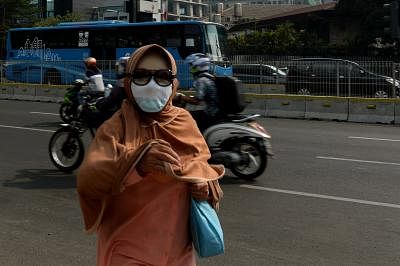 JAKARTA, Aug. 2, 2019 (Xinhua) -- A woman wears a mask due to air pollution on street in Jakarta, capital of Indonesia, Aug. 2, 2019. (Xinhua/Agung Kuncahya B./IANS)