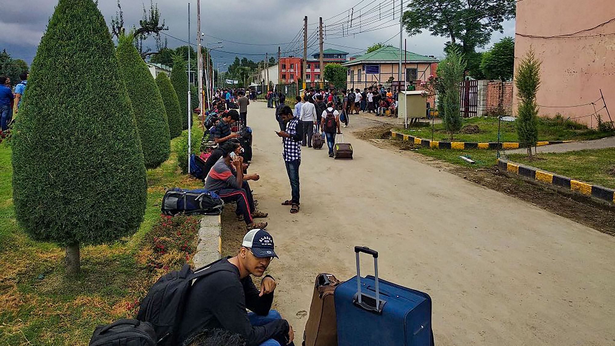 Non-local NIT students wait for vehicles as they prepare to leave the Valley after the government issued a security advisory for tourists and Amarnath yatris to curtail their stay in Kashmir.