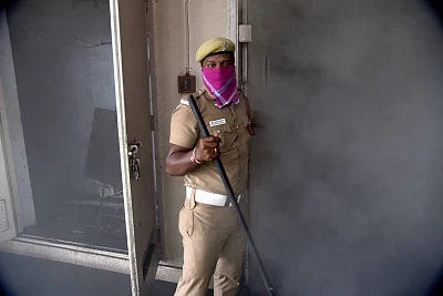 Chennai: A police personnel at the Harbour Telephone Exchange of the Bharat Sanchar Nigam Ltd (BSNL) where a fire broke out affecting mobile, landline and broadband connectivity in the area, in Chennai on Aug 1, 2019. (Photo: IANS)
