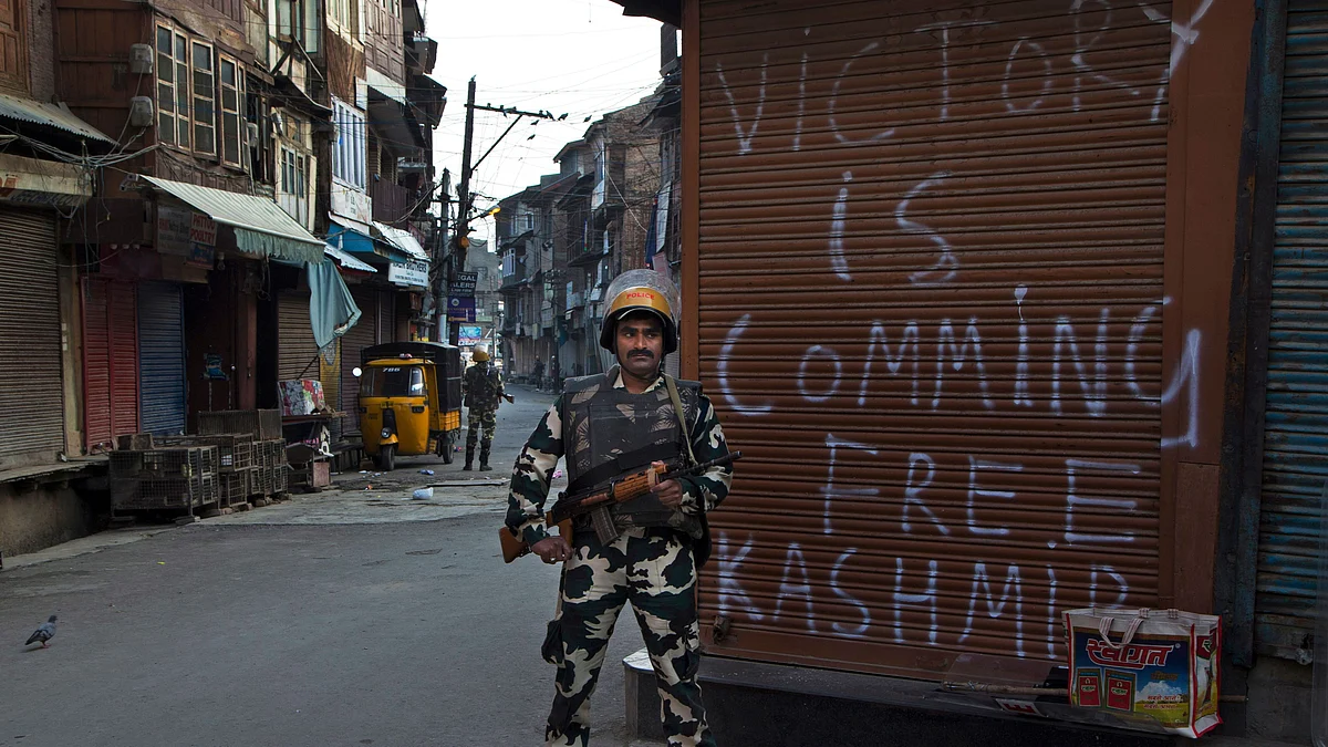 An Indian paramilitary soldier stands guard during curfew enforced to quell protestors in Srinagar.