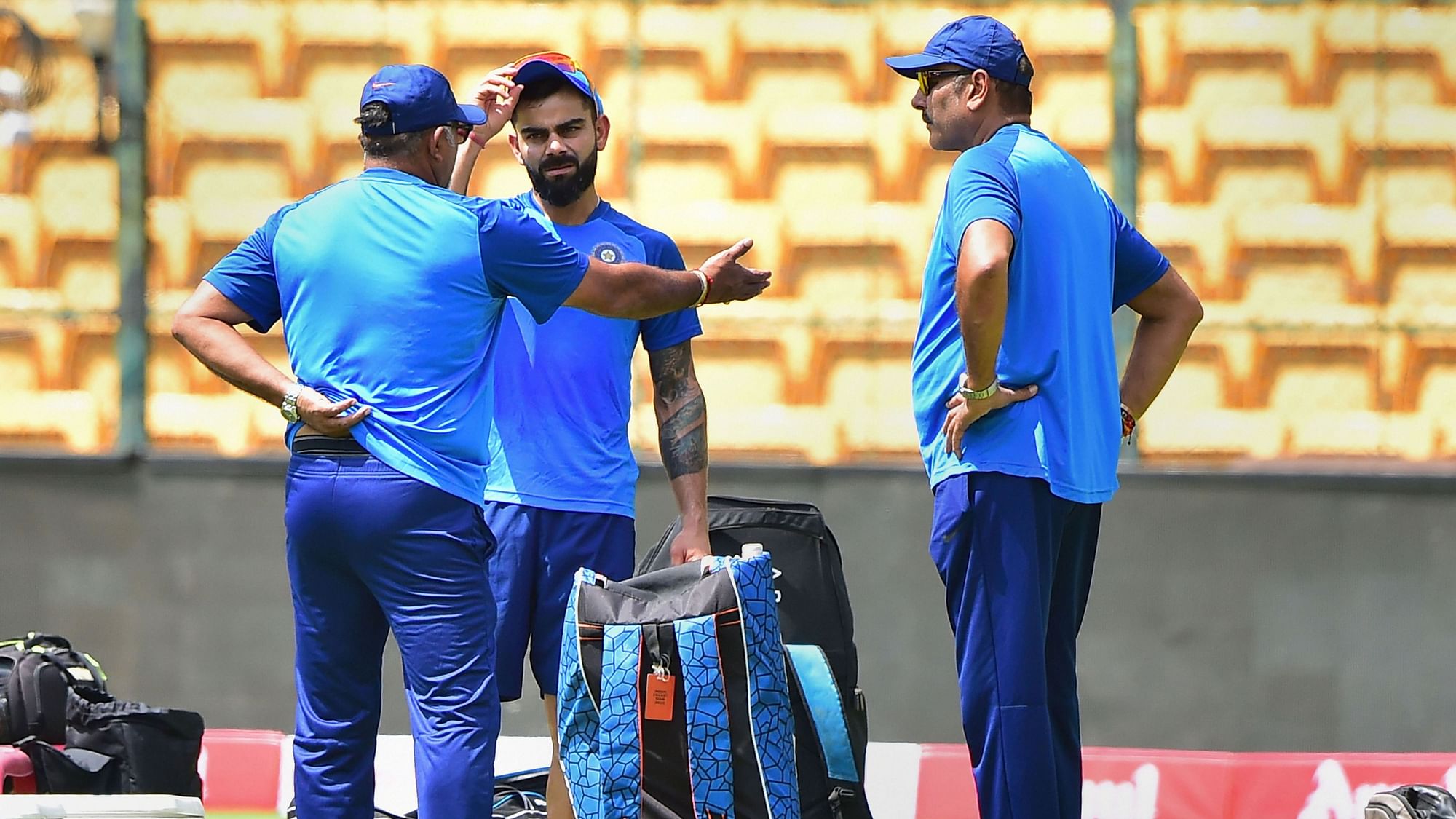 Indian captain Virat Kohli with head coach Ravi Shastri and bowling coach Bharat Arun during a training session.