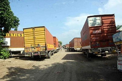Gurugram: Slowdown Pain: Trucks stranded in Gurugram due to want of work, as demand from auto industry recede on the back of a sales slowdown. (Photo: Bidesh Manna/IANS)